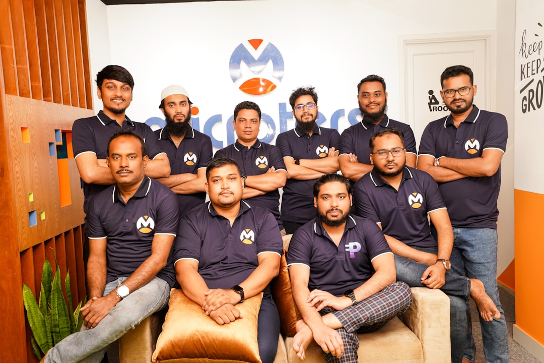 A group of men sitting next to each other happy team, delivery train, software launch, success