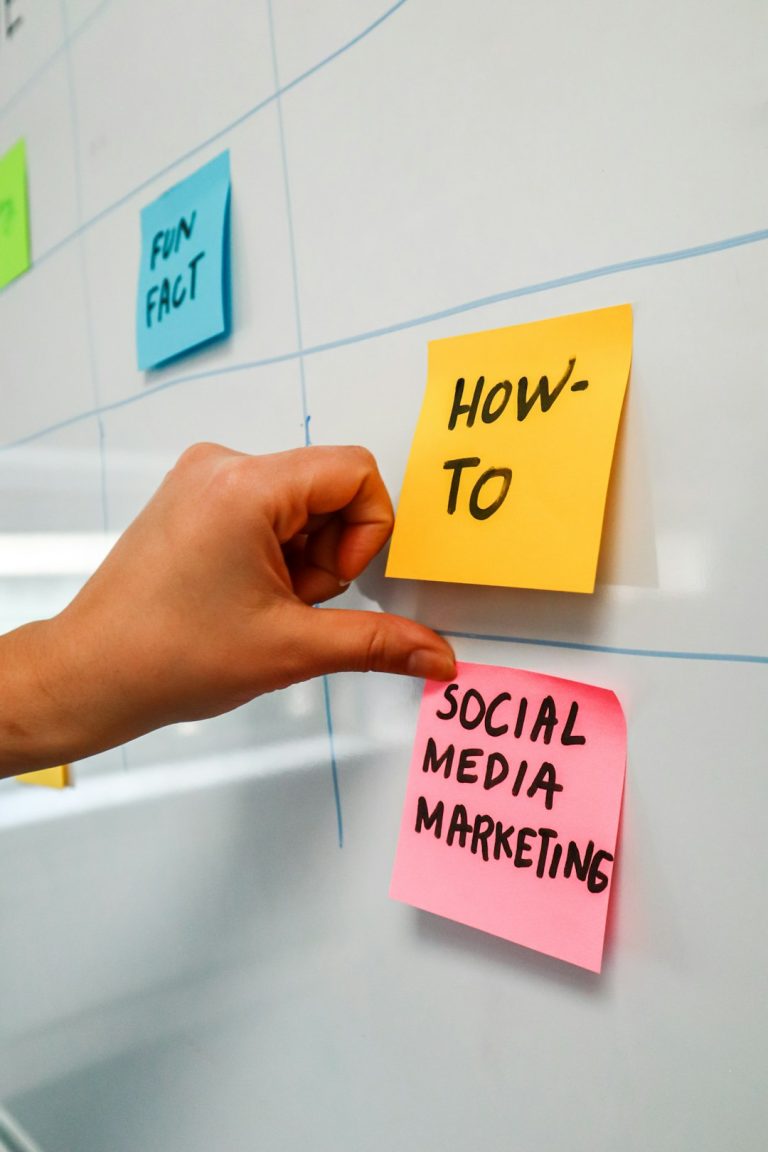 a hand is pointing to sticky notes on a bulletin board email tags, customer segments, marketing workflow