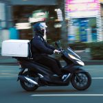 a man riding a scooter with a box on the back of it order tracking, delivery scooter, mobile notification