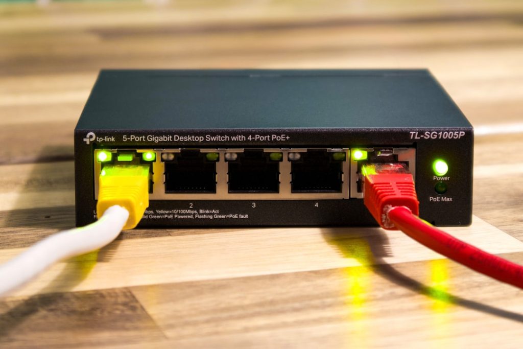 A network switch with ethernet cables connected. router label, wifi password, home internet