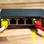 A network switch with ethernet cables connected. router label, wifi password, home internet