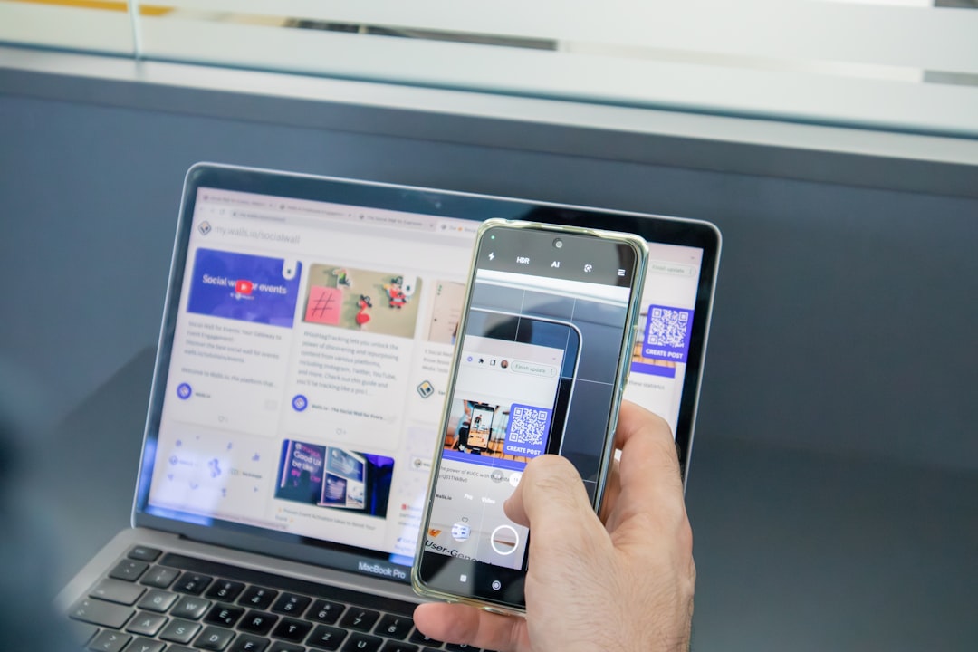 a person holding a cell phone and a laptop browser testing, laptops, mobile phones, quality assurance