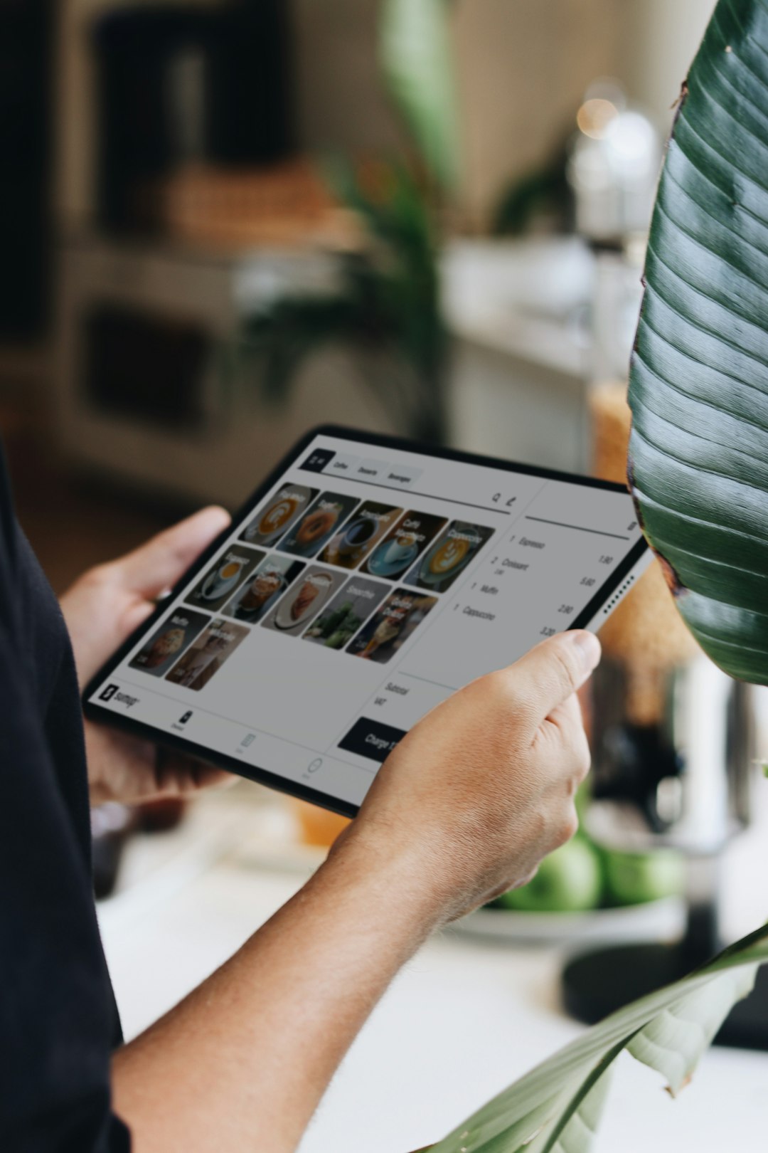 A person holding a tablet in their hands restaurant software, sales analytics, tablet pos, menu reports