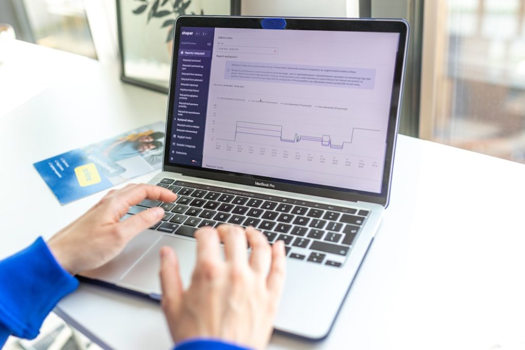 a person using a laptop computer on a desk ecommerce dashboard, paypal tracking, shipment automation