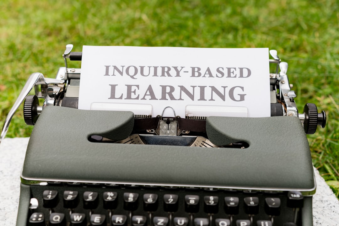 a typewriter with a sign that says inquiry - based learning course checklist, learning goals, enrollment decision