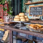 Bakery display case with pastries and bread small shop owner, bakery counter, friendly business