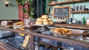 Bakery display case with pastries and bread small shop owner, bakery counter, friendly business