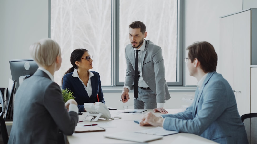 Business professionals in a meeting around a table. manager employee meeting, workplace clarity, professional feedback