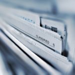 Classified page 5 newspaper selective focus photography case files, legal analytics, workflow automation, litigation