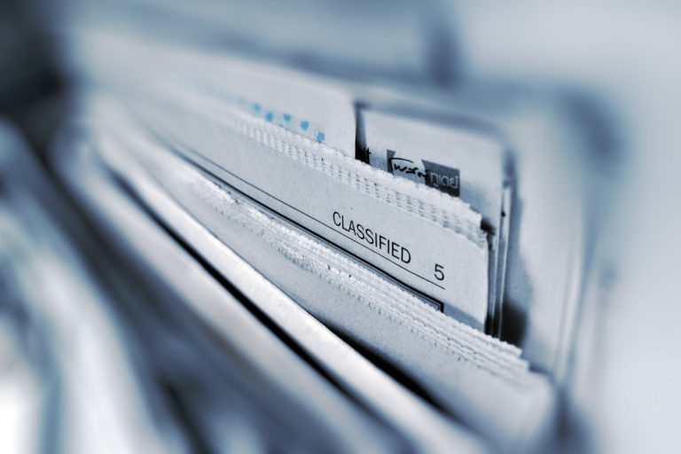 Classified page 5 newspaper selective focus photography case files, legal analytics, workflow automation, litigation
