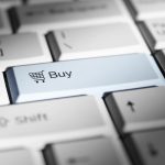 Close-up of a keyboard with a prominent 'buy' button. online store, shopping cart, performance chart, customer checkout