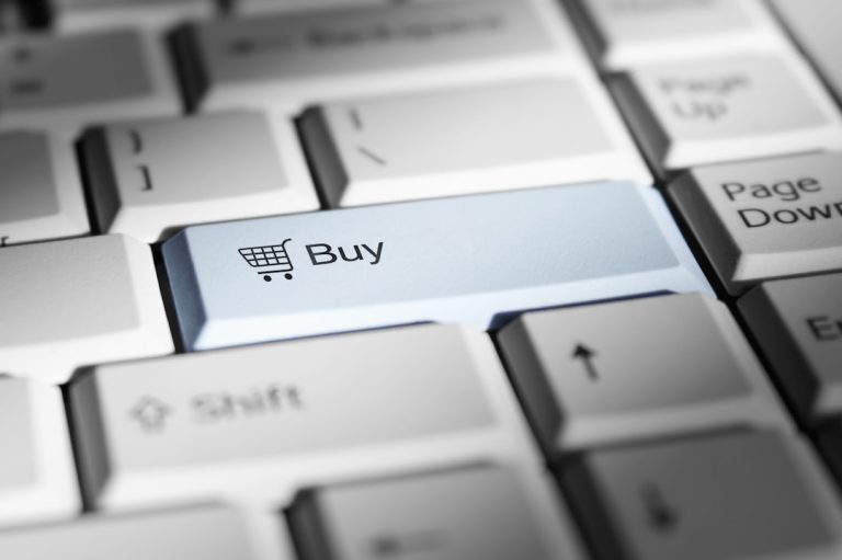 Close-up of a keyboard with a prominent 'buy' button. online store, shopping cart, performance chart, customer checkout