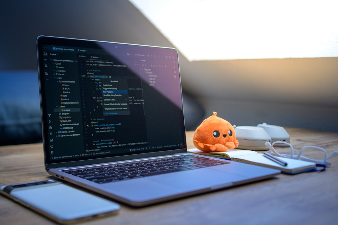 Laptop with code, phone, glasses, and plush toy. payment dashboard, api integration, developer workspace