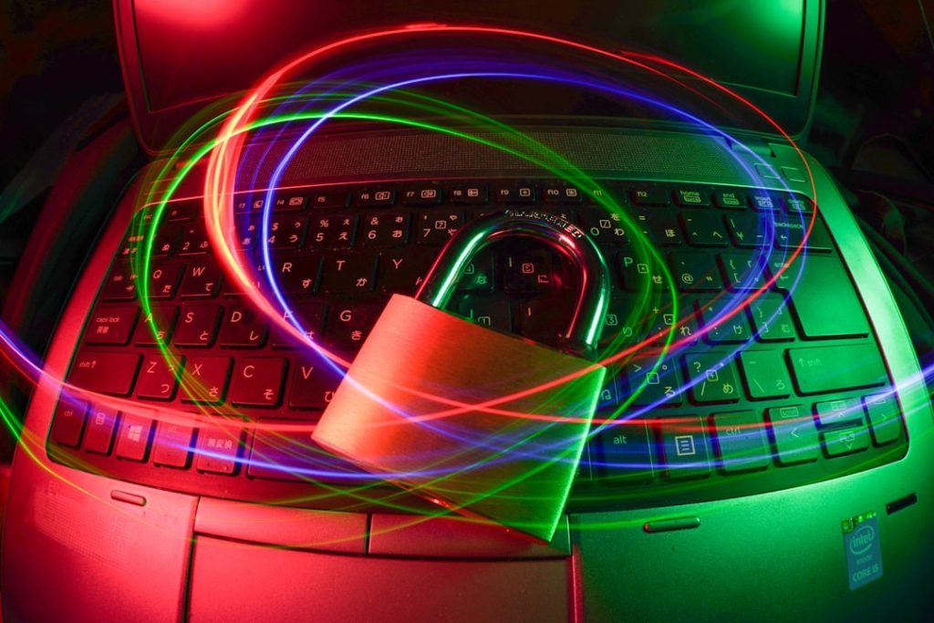 padlock on laptop with light trails wifi security, strong password, connected devices