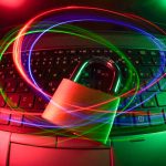 padlock on laptop with light trails wifi security, strong password, connected devices