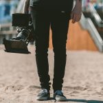 person holding shoulder-mount camcorder video production, filmmaker, online portfolio