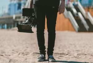 person holding shoulder-mount camcorder video production, filmmaker, online portfolio
