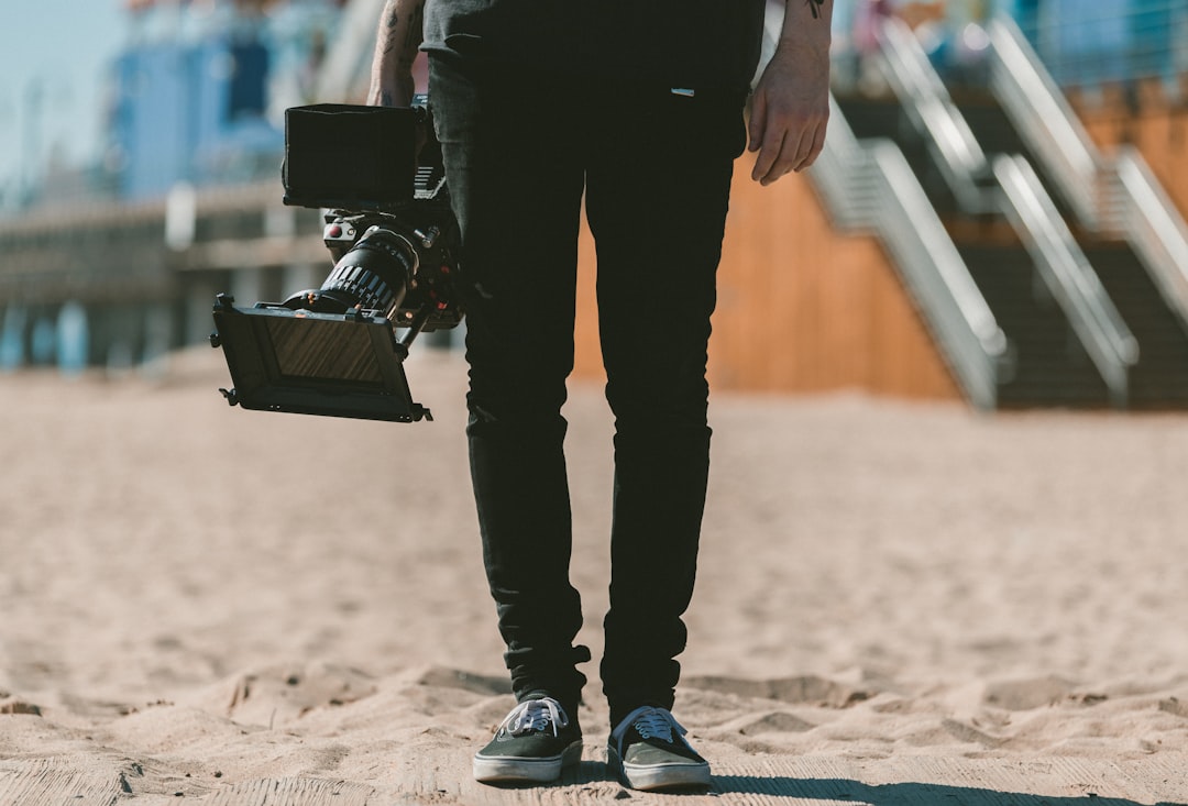 person holding shoulder-mount camcorder video production, filmmaker, online portfolio