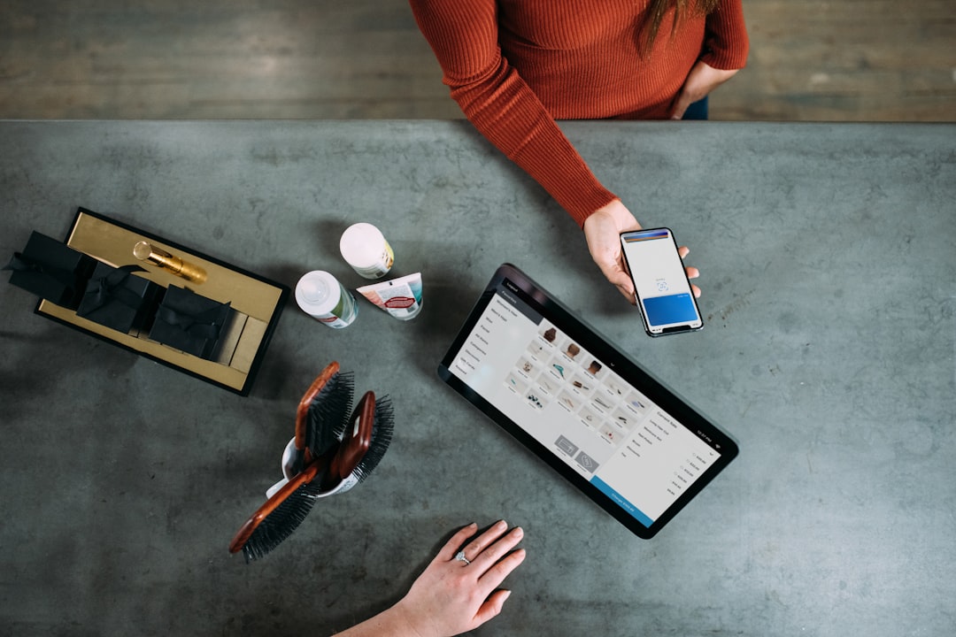 person holding smartphone beside tablet computer global commerce, mobile checkout, online payments, merchants