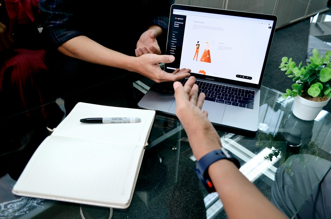 person using macbook pro on white table user research, website testing, usability session