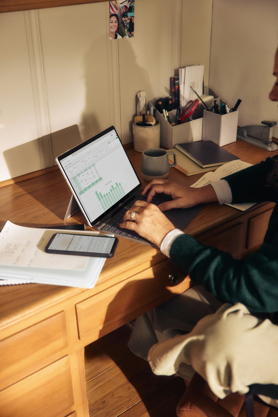Person working on laptop at a wooden desk. lawyer laptop documents automation