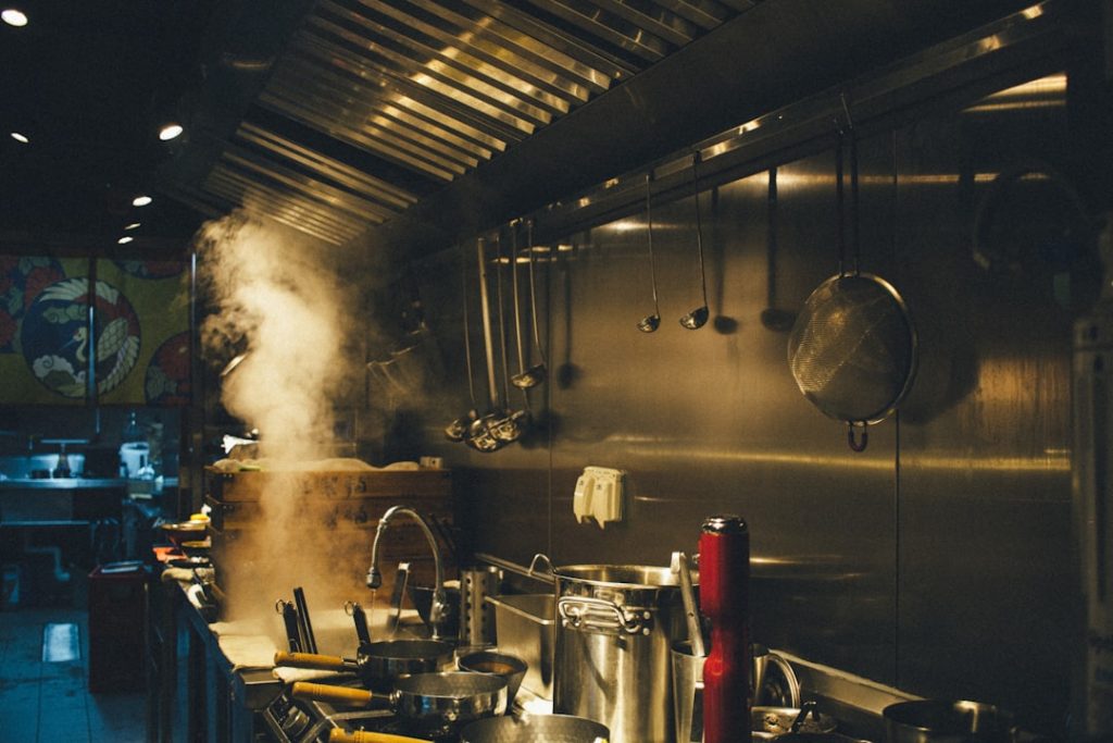 stainless steel cooking pots on stove kitchen display, restaurant orders, chefs, indian food