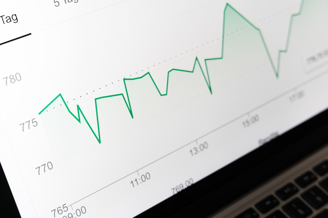 stock market chart displayed on laptop screen revenue chart, sales growth, financial report