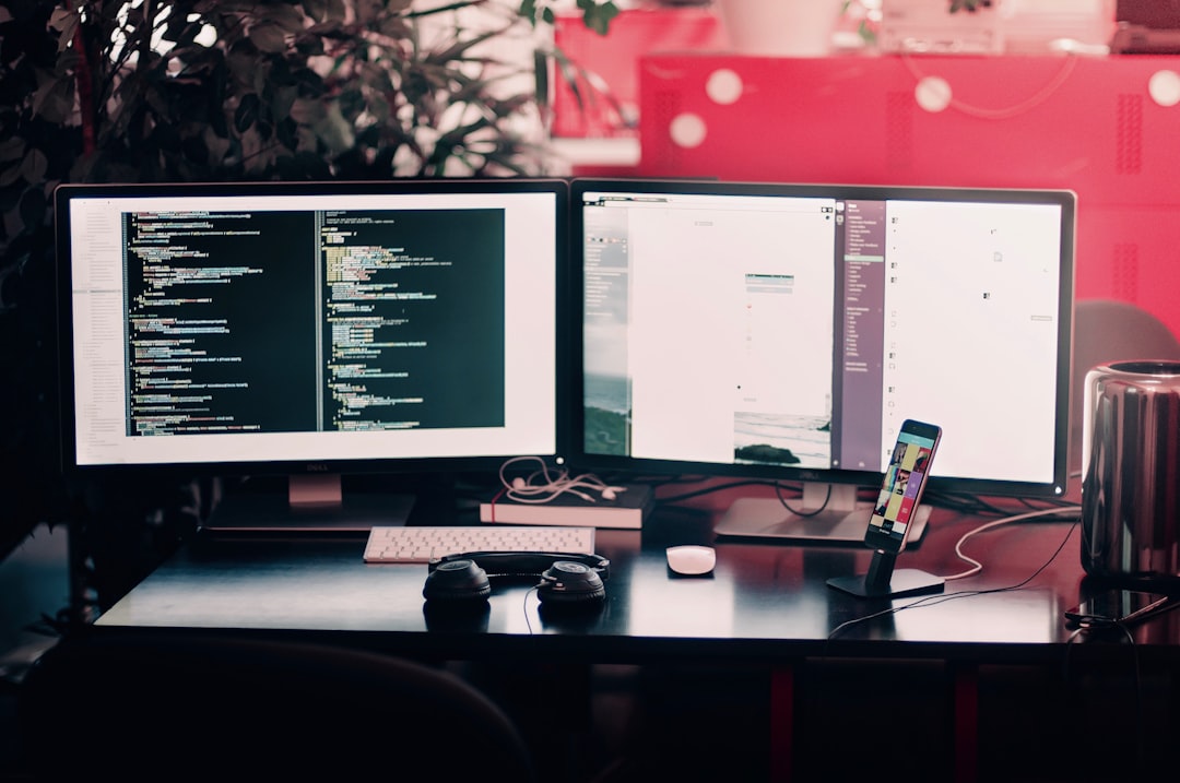 two black computer monitors on black table software prototype, ai coding assistant, web application design