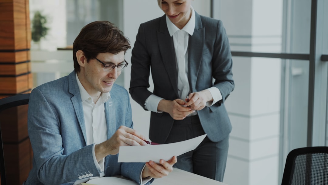Two business people reviewing documents together manager employee meeting, workplace clarity, professional feedback