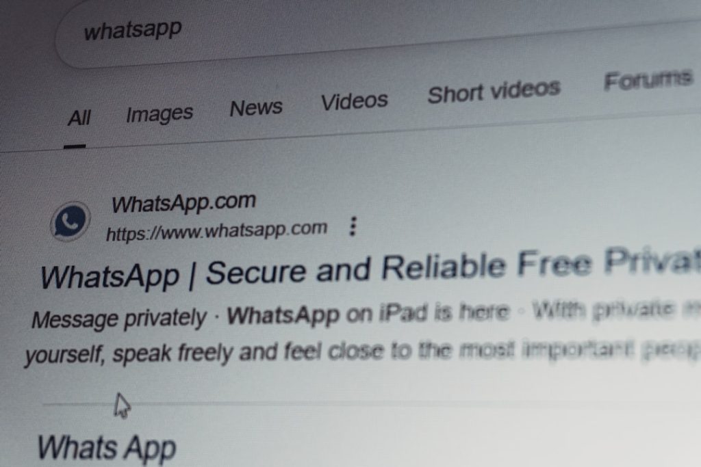 Whatsapp search results on a computer screen. email security, external contact, warning popup