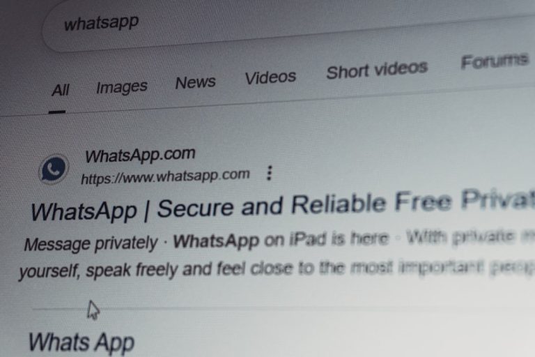 Whatsapp search results on a computer screen. email security, external contact, warning popup