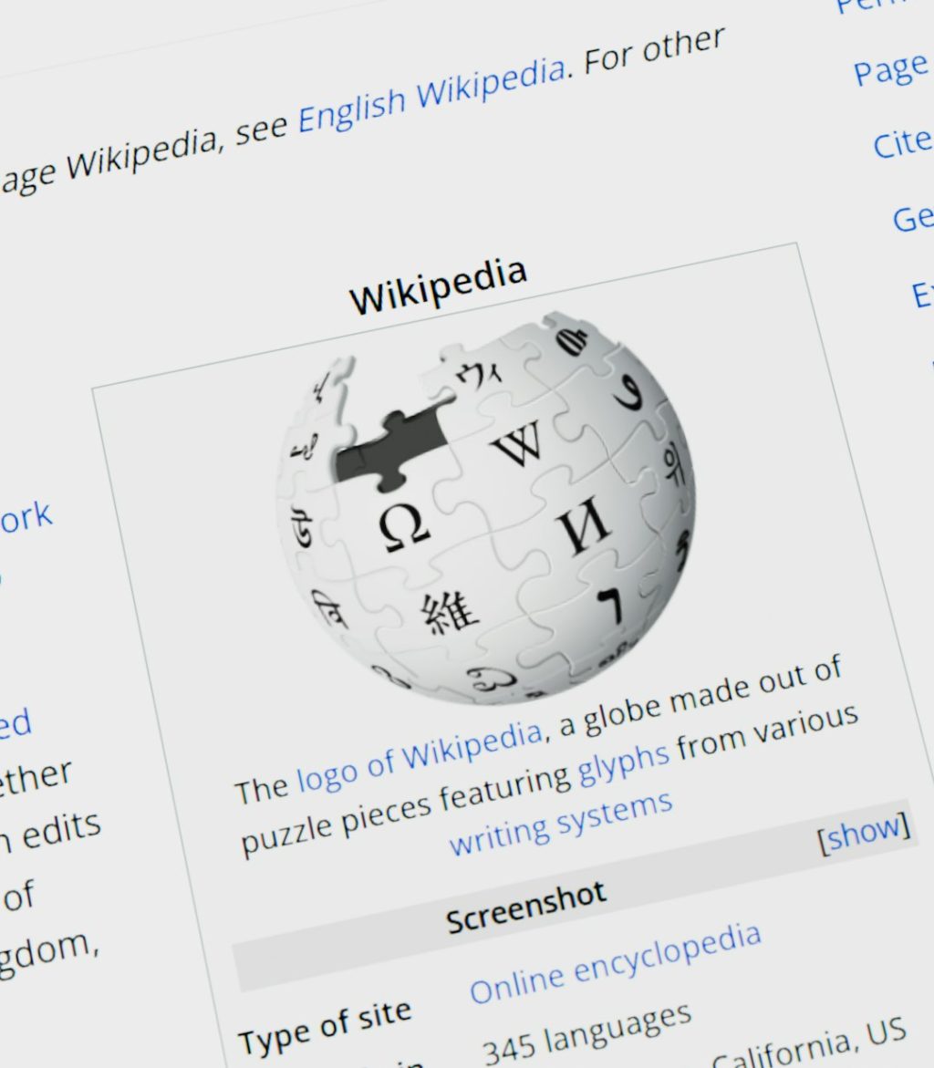 Wikipedia logo globe with text on screen website migration, search rankings, redirect map