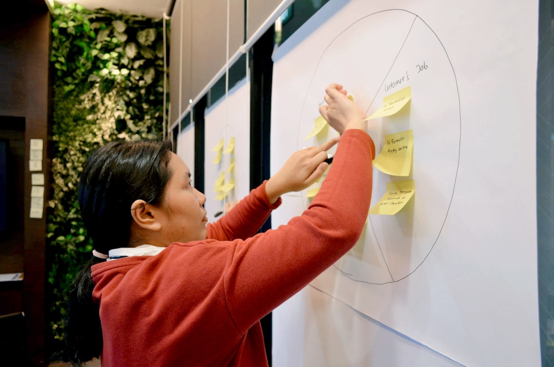 woman in red long sleeve shirt holding white paper market sizing, business strategy, nested circles, startup planning