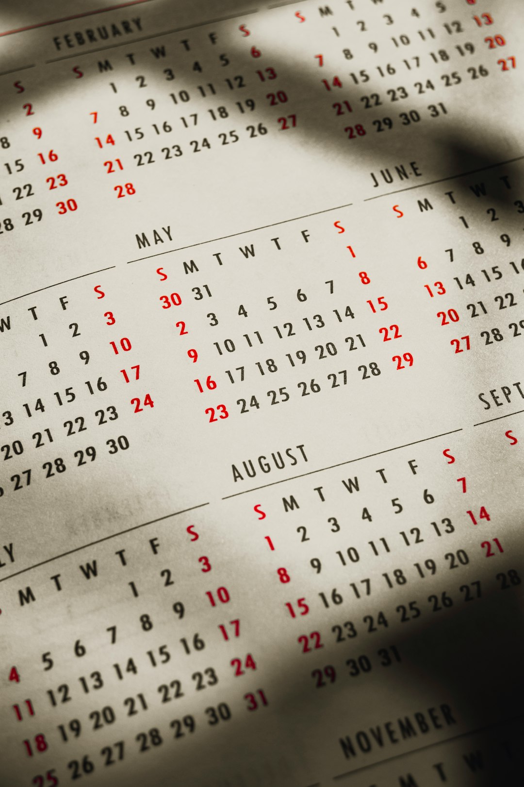 a close up of a calendar on a table content calendar, search intent, editorial planning