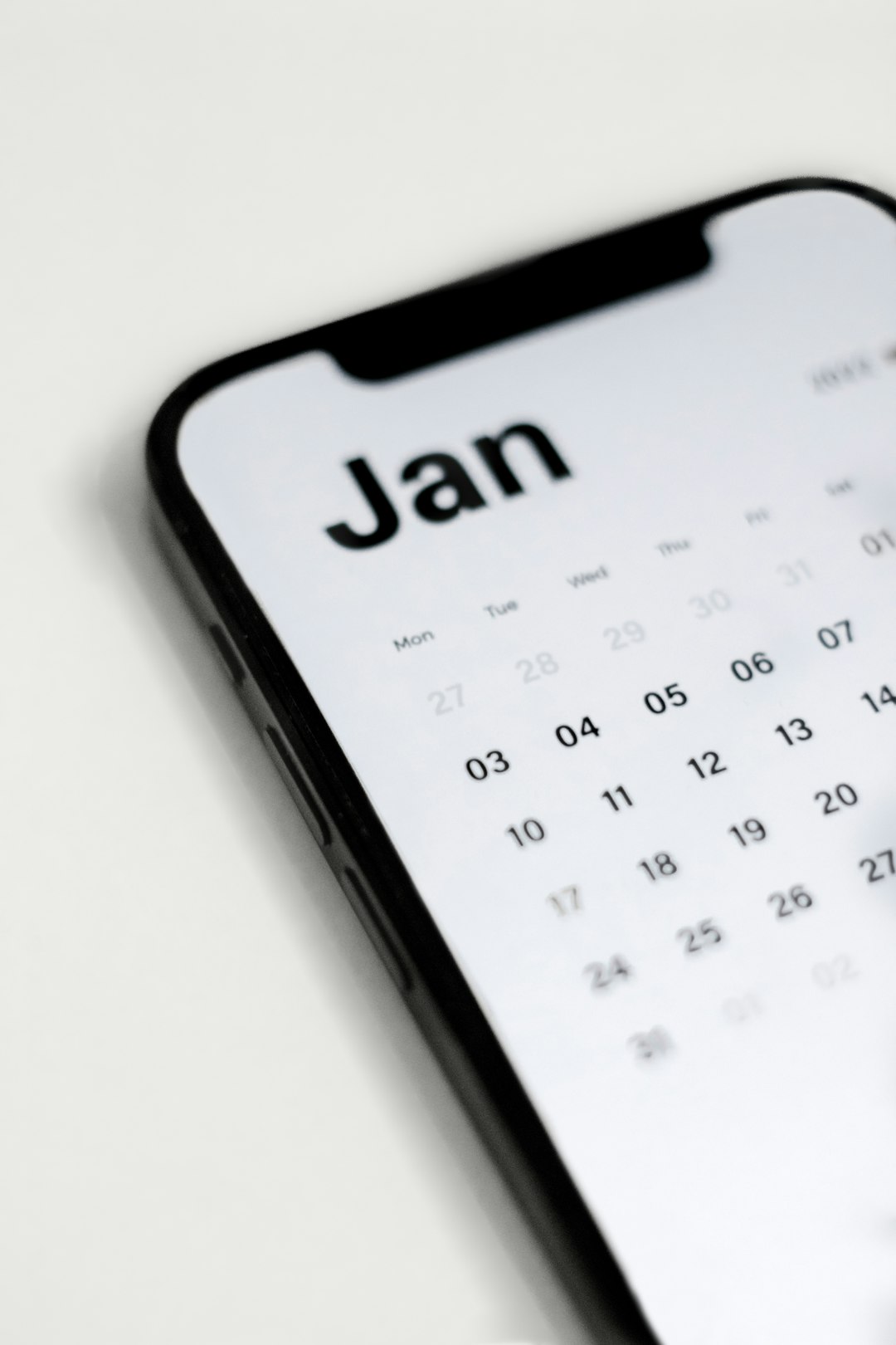 a close up of a cell phone with a calendar on it email calendar, outreach schedule, podcast planning