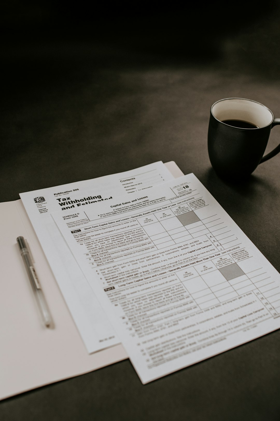black ceramic mug beside white printer paper invoice automation, finance team, document processing