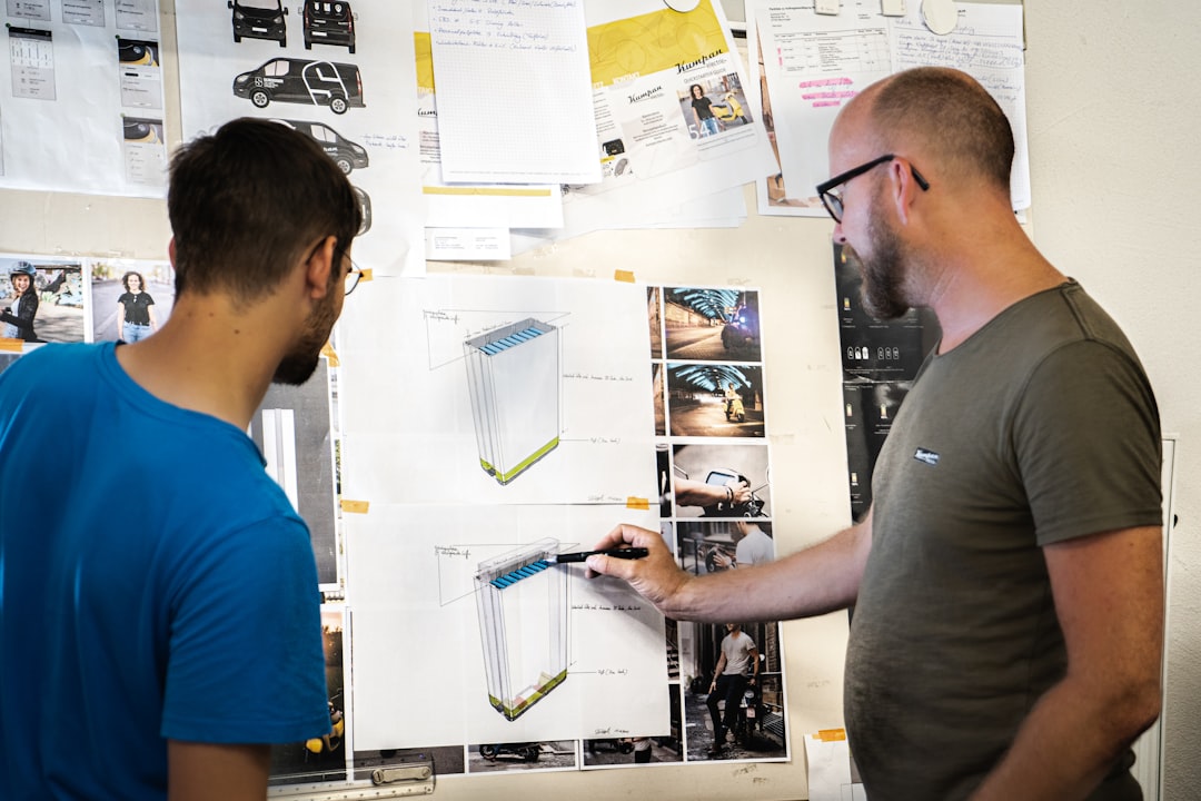 man in blue crew neck t-shirt holding white printer paper product lifecycle, engineering team, digital workflow, connected data