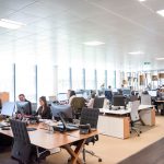 people working at desks in open office customer service team, ai assistant, call center, support workflow