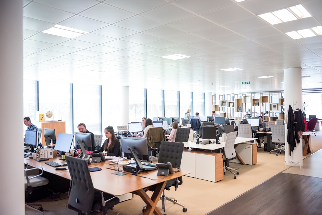 people working at desks in open office customer service team, ai assistant, call center, support workflow