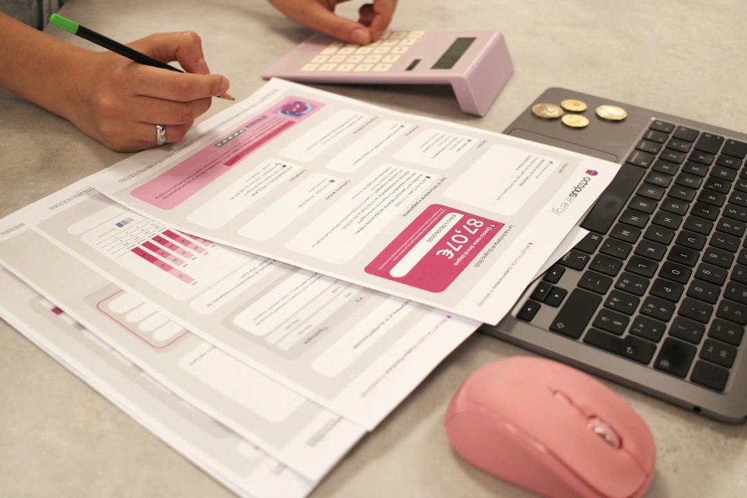 Someone is doing taxes with a calculator and laptop invoice automation, finance team, document processing