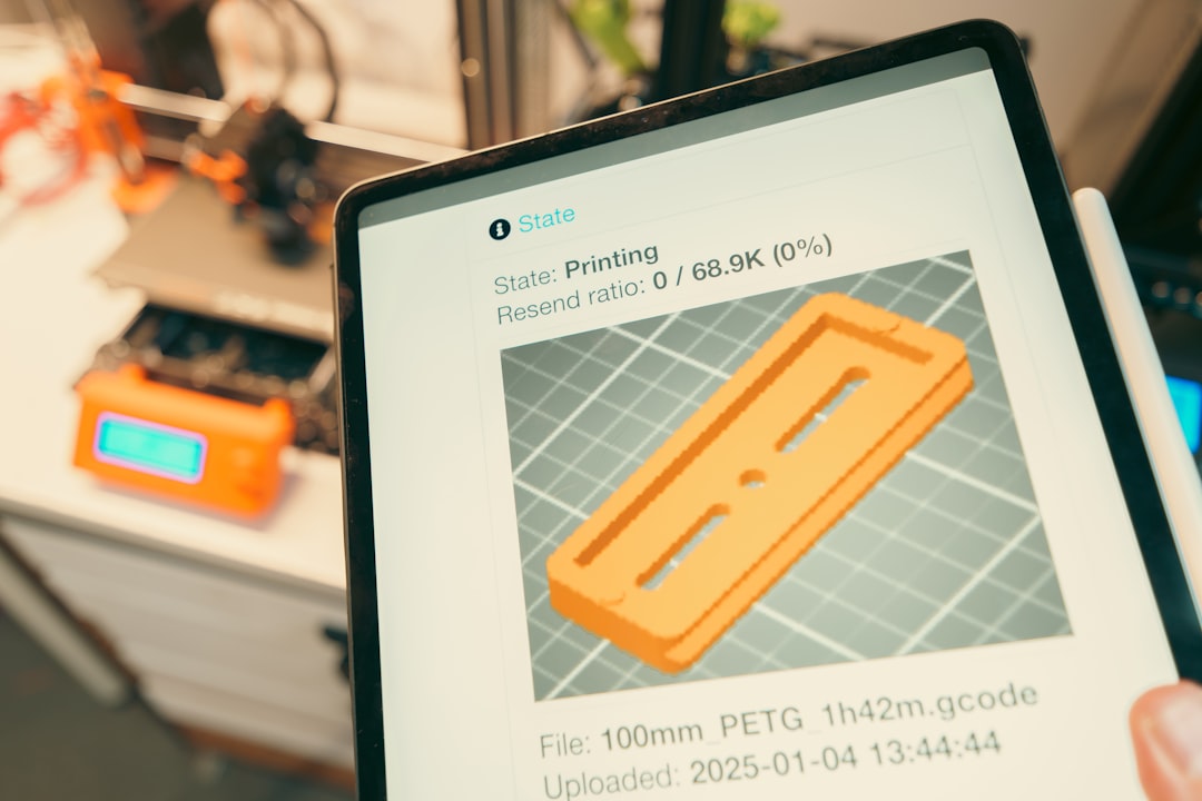 Tablet displaying 3D print progress with printer in background. cad comparison, drafting software, design tools