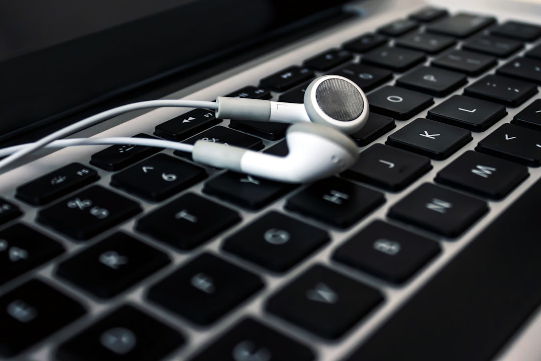 white earbuds laptop phone headphones, mp3 playback, file compatibility