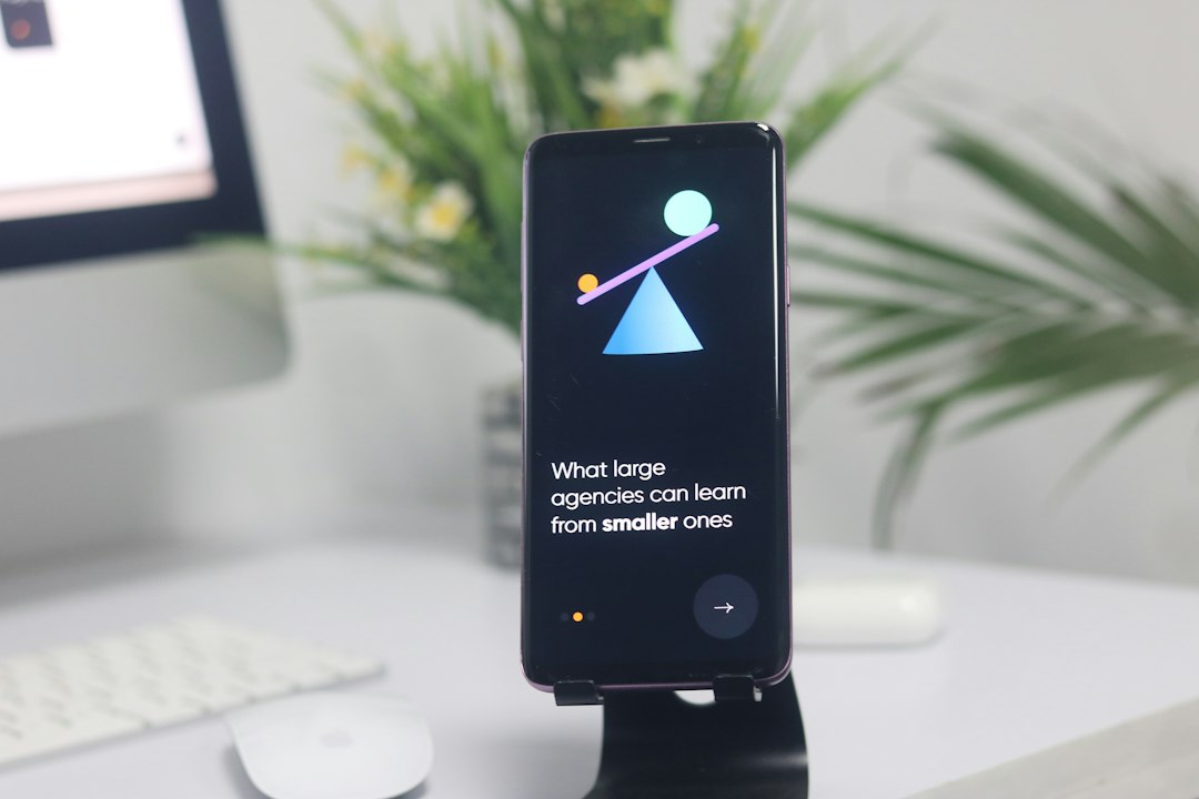 a cell phone on a stand on a desk workspace apps, phone productivity, travel work, notes comparison