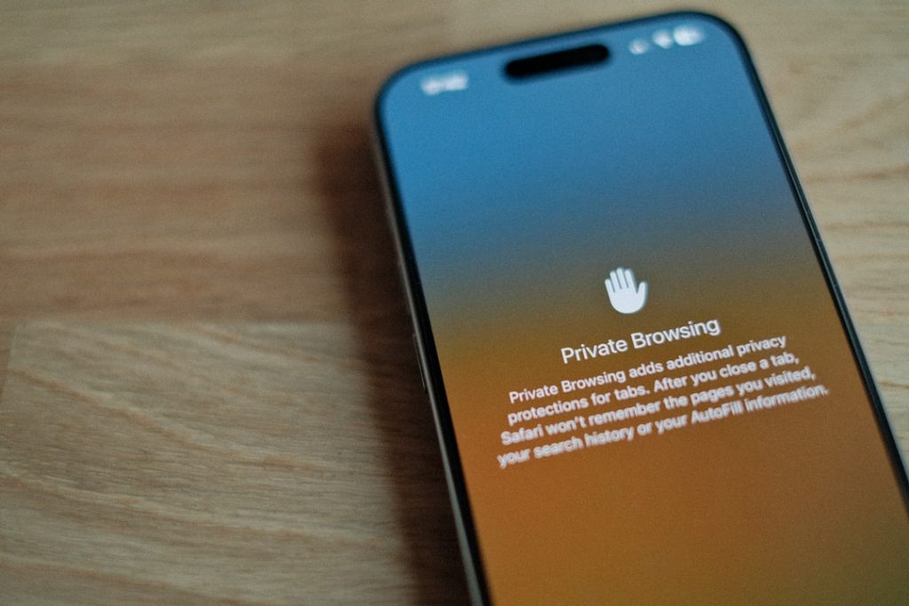A cell phone sitting on top of a wooden table app permissions, sync settings, security review