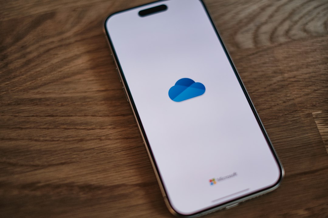 A close up of a cell phone on a table editing document, iphone screen, cloud upload