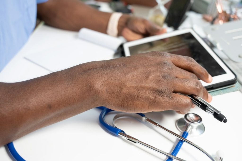 a close-up of a hand on a laptop healthcare privacy, secure data, medical compliance
