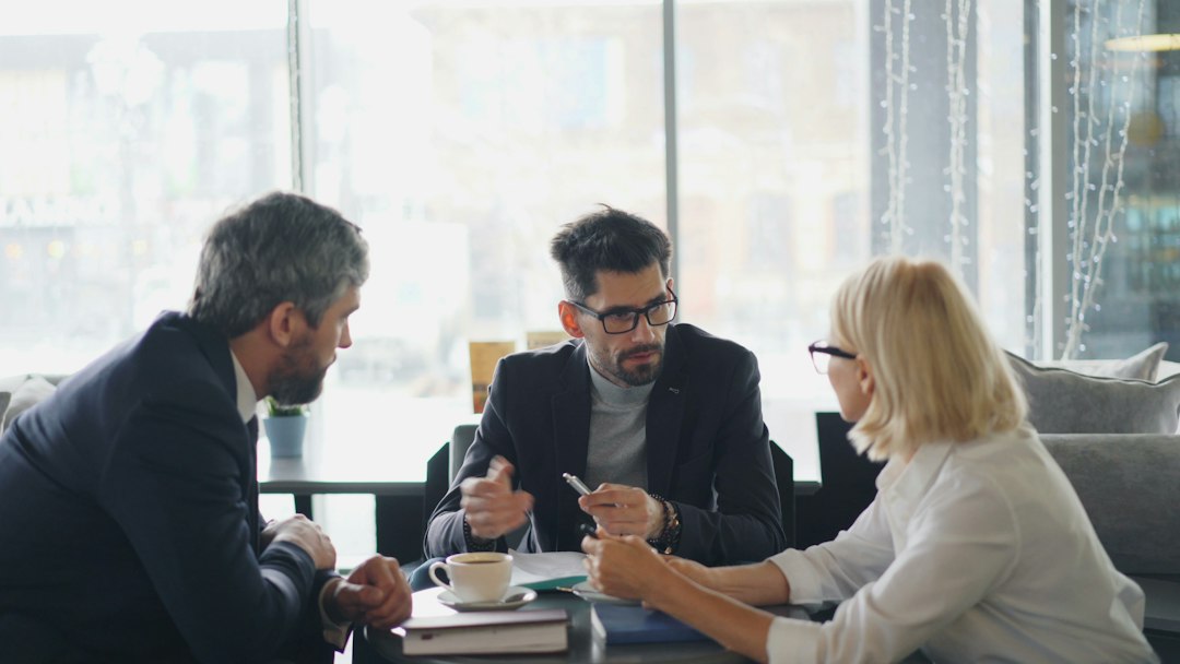 a group of people sitting around a table business meeting, sales strategy, interview notes