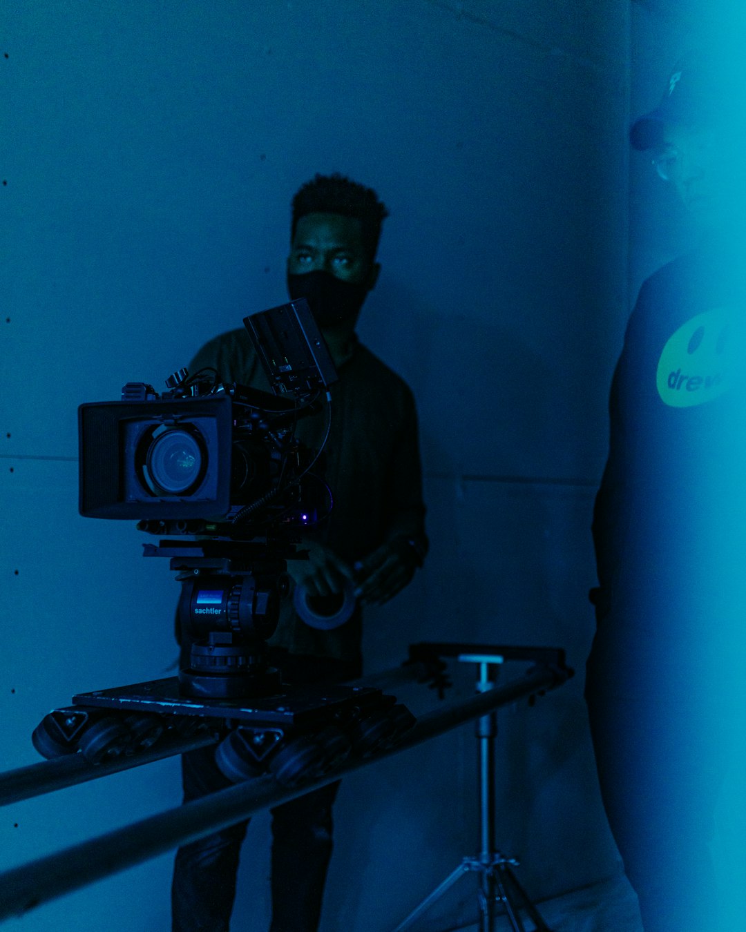 a man holding a camera in a dark room social media team review, reel feedback, content strategy