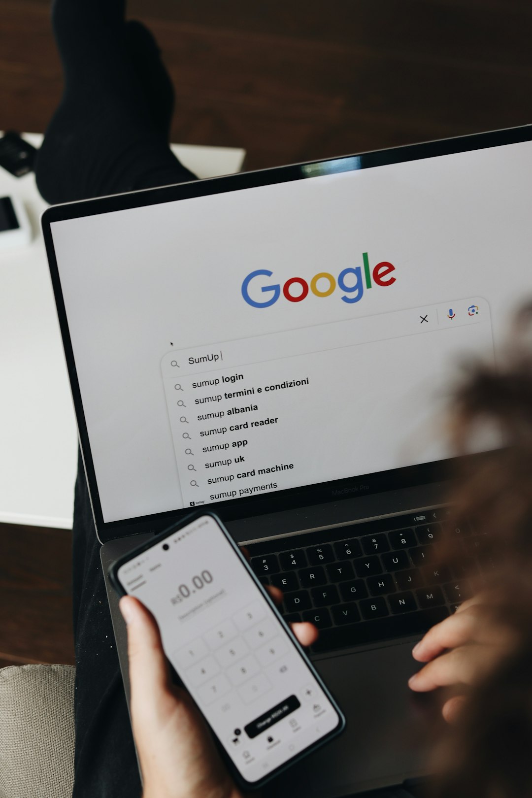 A person holding a cell phone and a laptop seo checklist, website audit, structured data