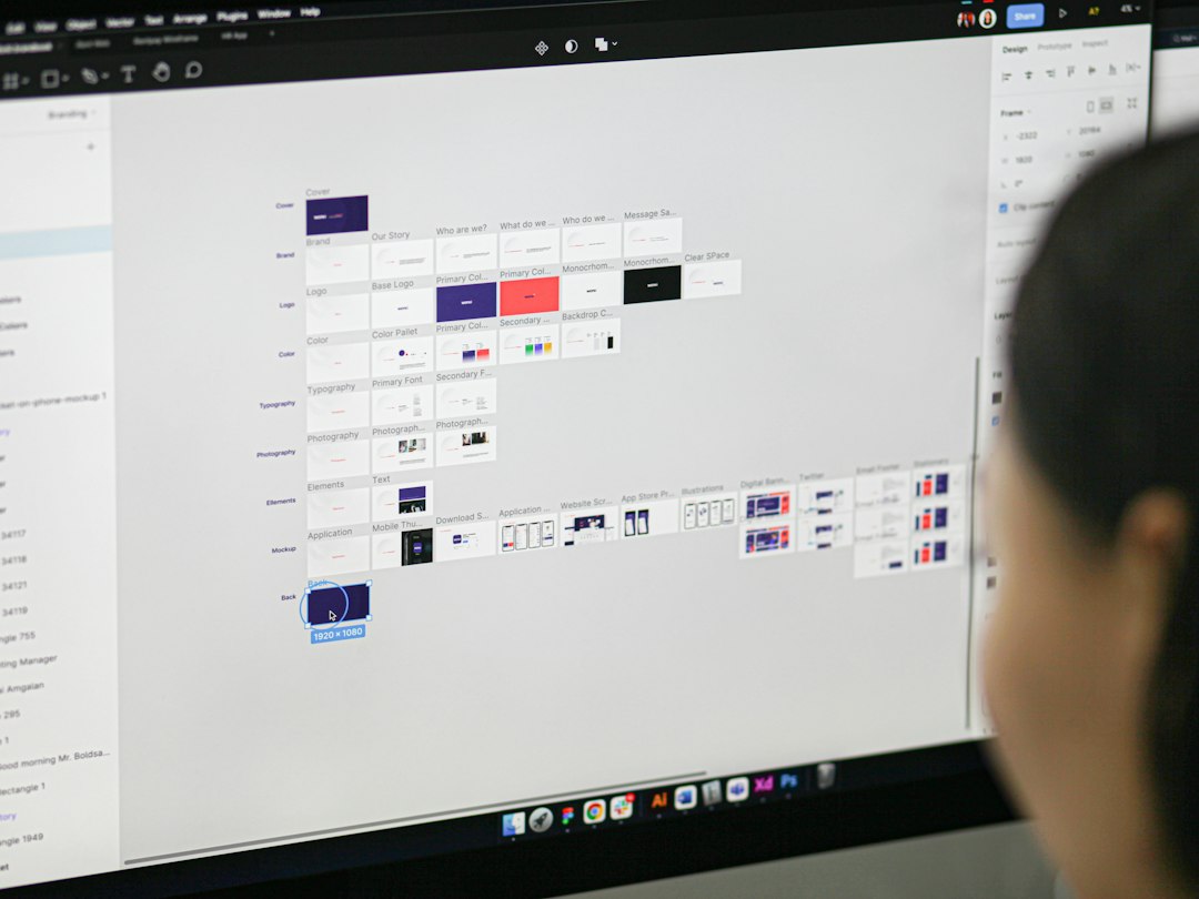 a woman is looking at a computer screen figma logo design, grid system, startup branding